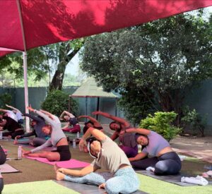 Yoga class performing mat-based poses