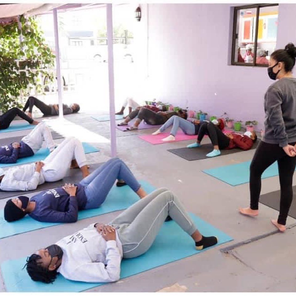 Yoga class stretching on mats